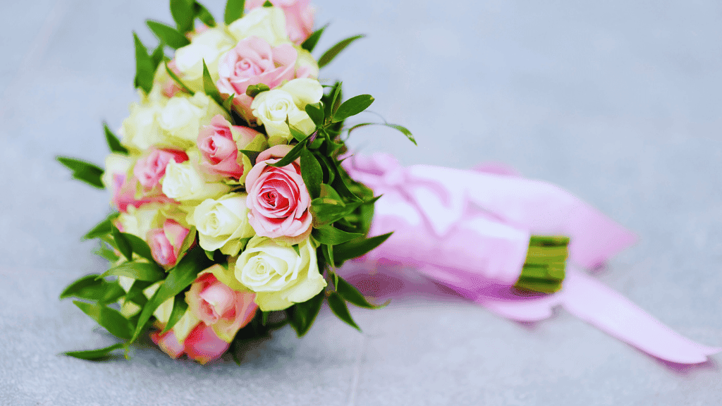 Pink and white bouquet of roses with pink ribbon